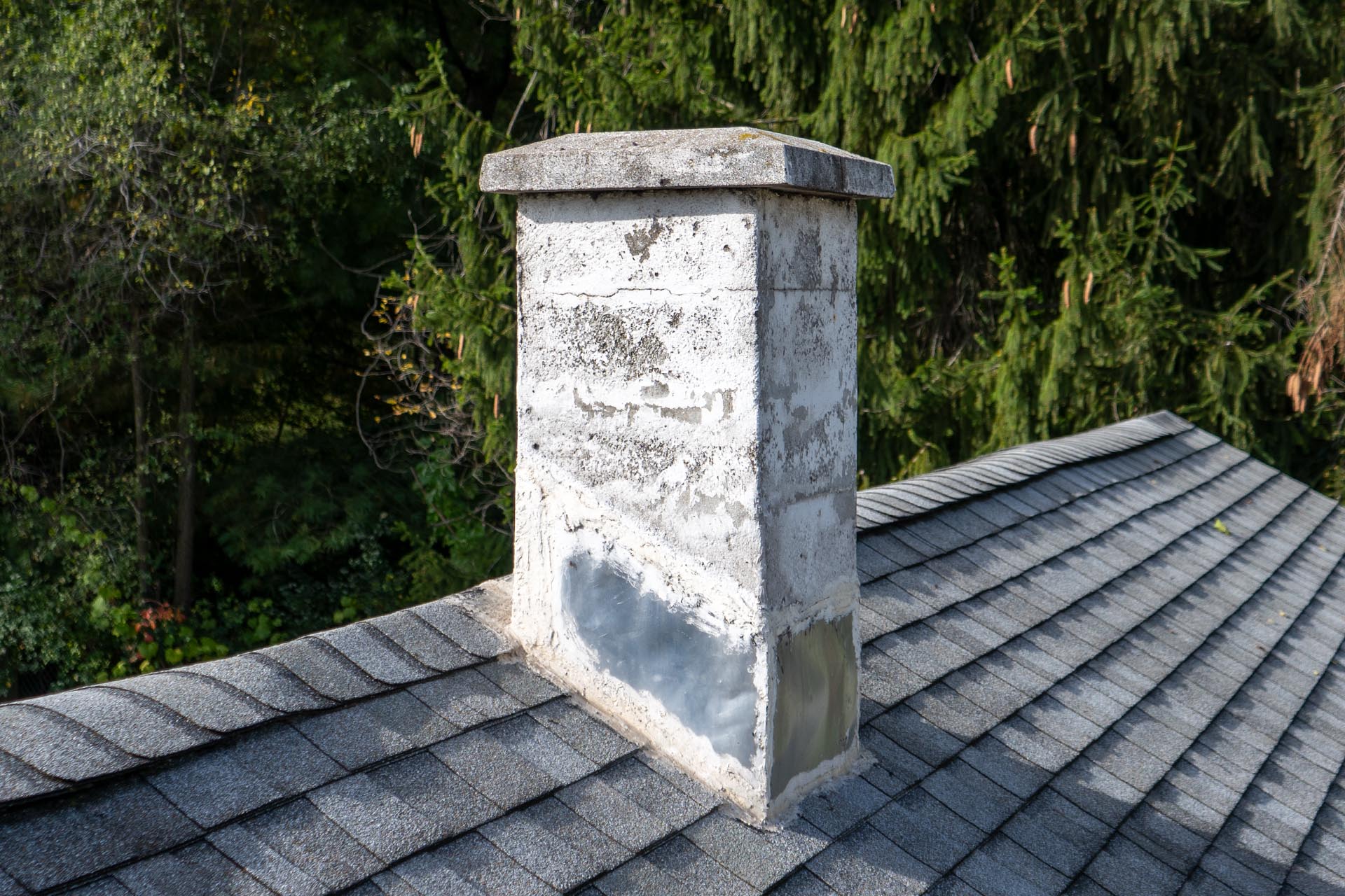 Before chimney repair, with leaking, improperly-installed flashing.